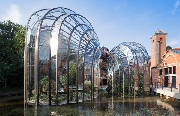 The intertwining botanical glasshouses are made from 893 individually shaped curved glass pieces