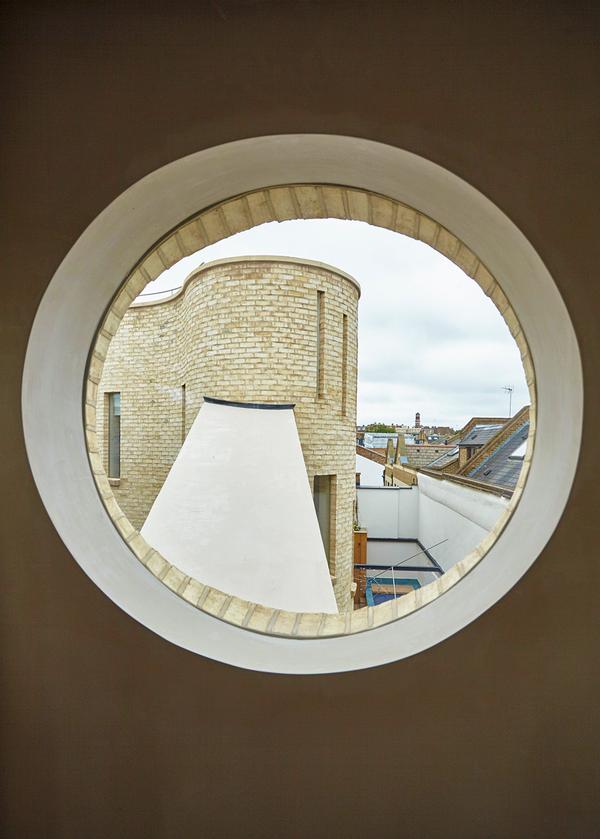 The home also features two curved towers, which house the bedrooms and a play area for the children 