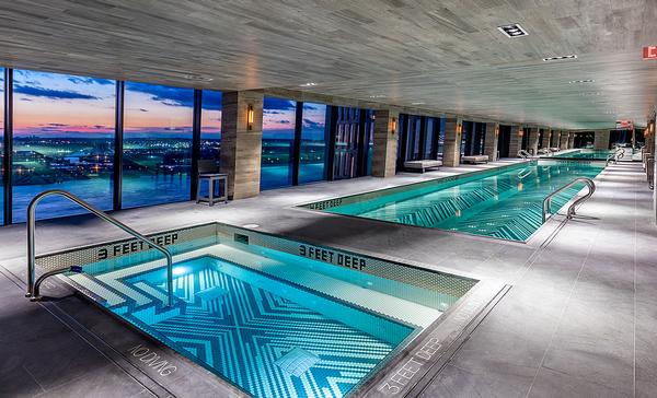 The glass skybridge that links the towers houses an indoor pool and hot tub, as well as 
a residents’ bar and lounge / Photo: Max Touhey