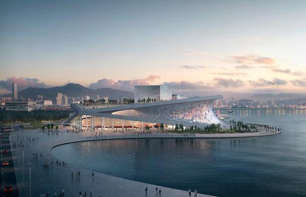 The Busan Opera House in South Korea features an angled roof that curves down to meet the ground, allowing visitors to climb up to a public space on the rooftop