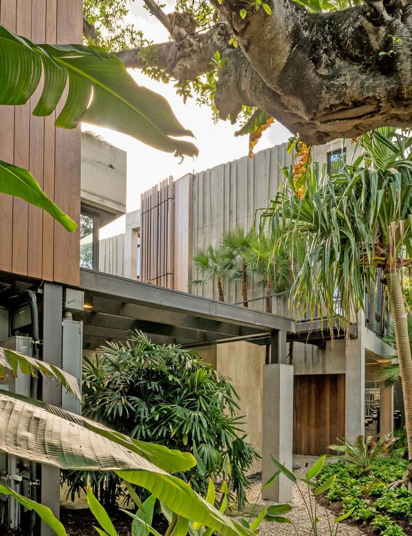 The house is elevated above a sculptural garden